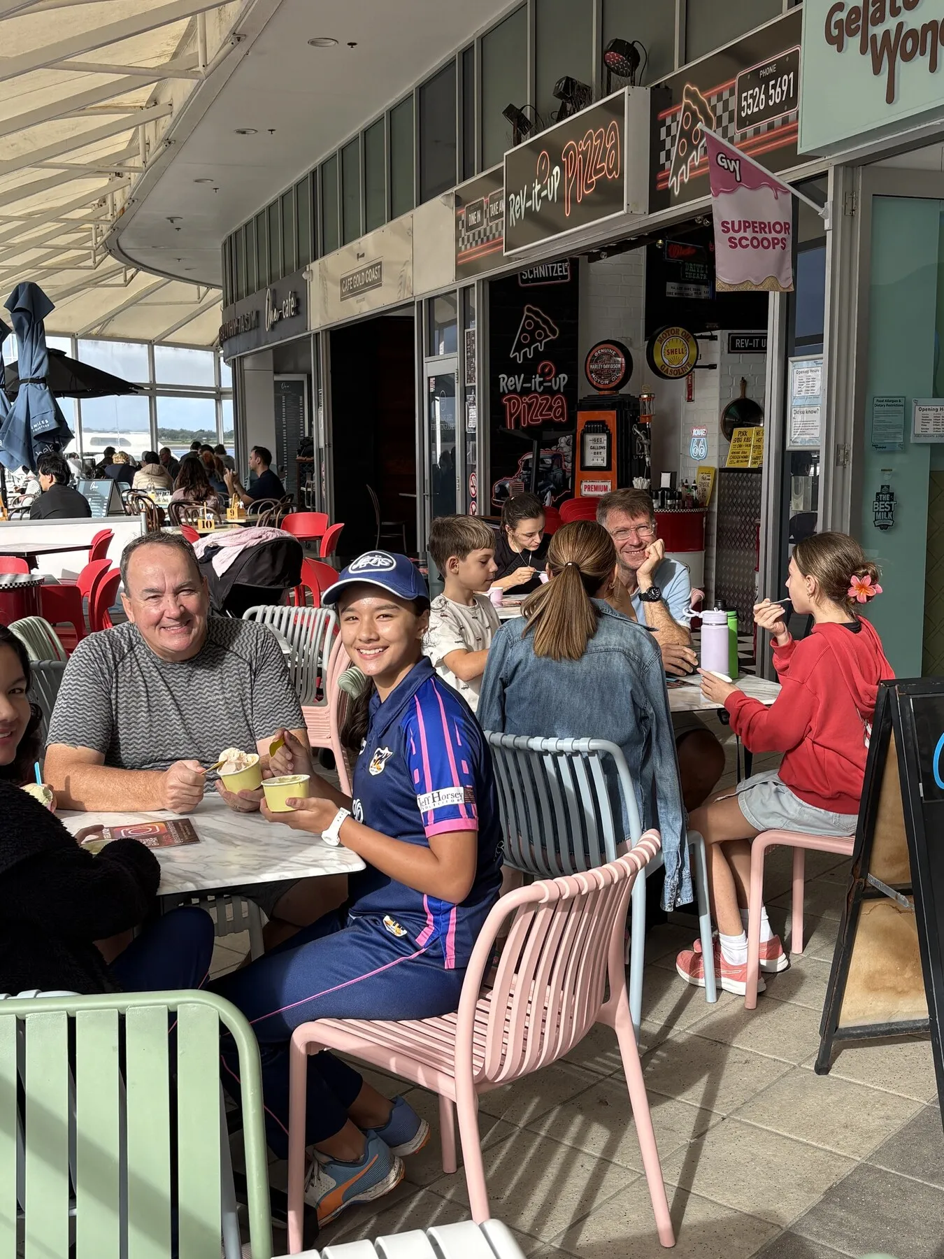 Customers enjoying gelato at the outdoor tables in front of Gelato Wonderland.